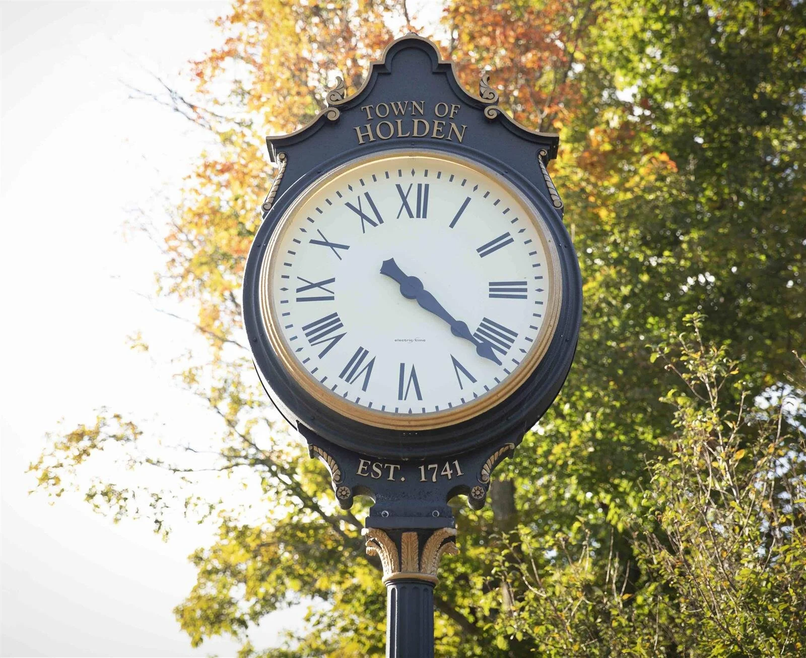 A clock that says town of holden on it