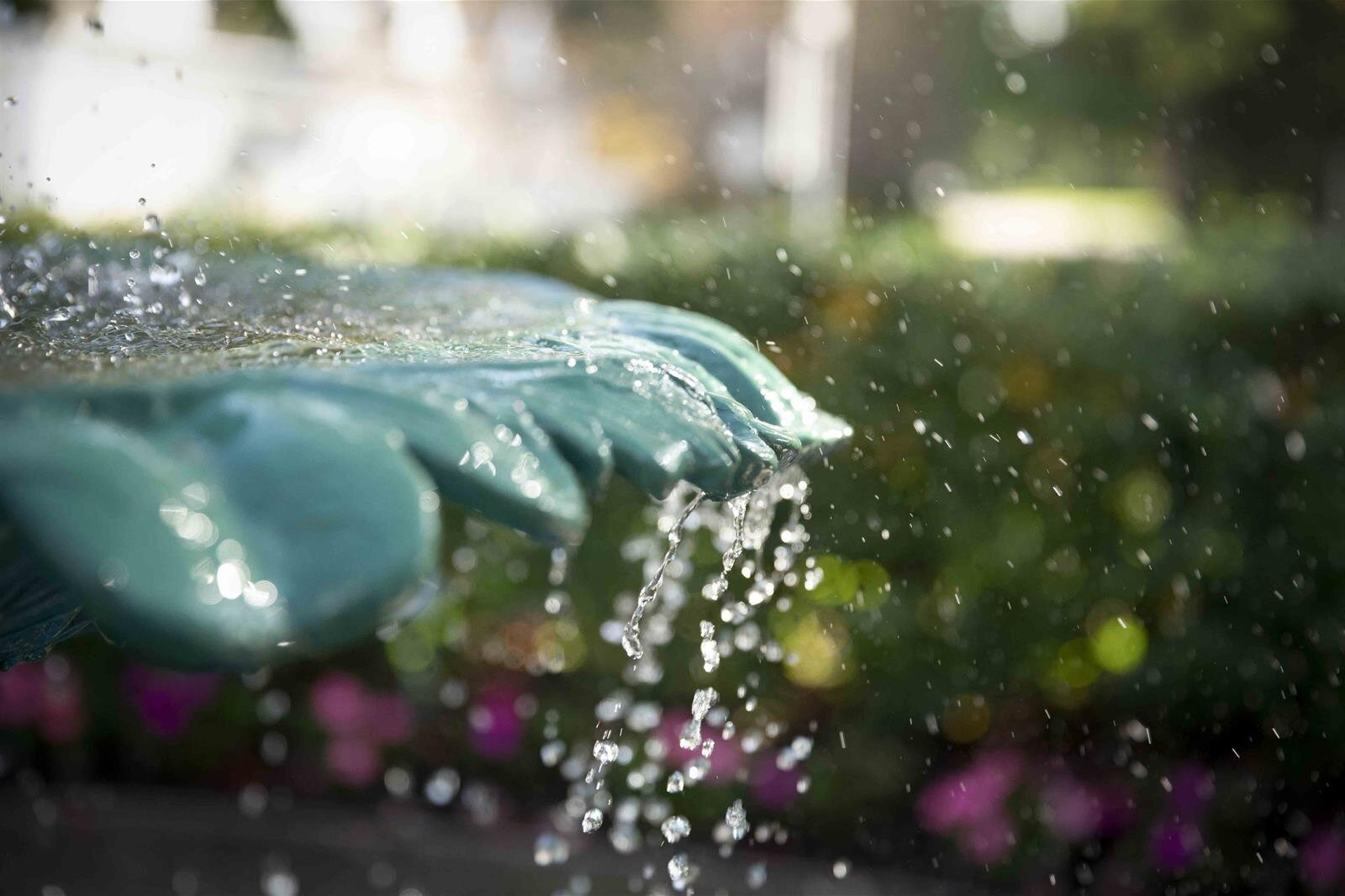 A close up of a fountain with water splashing out of it.