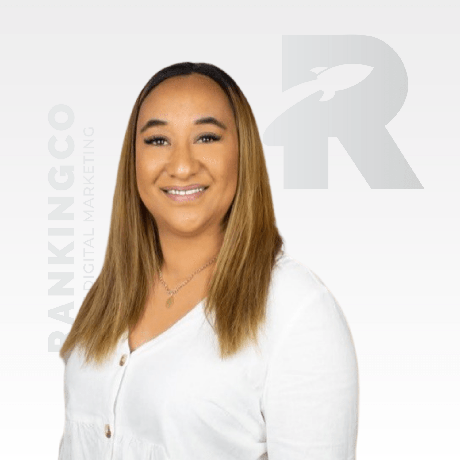 A woman in a white shirt is smiling for the camera