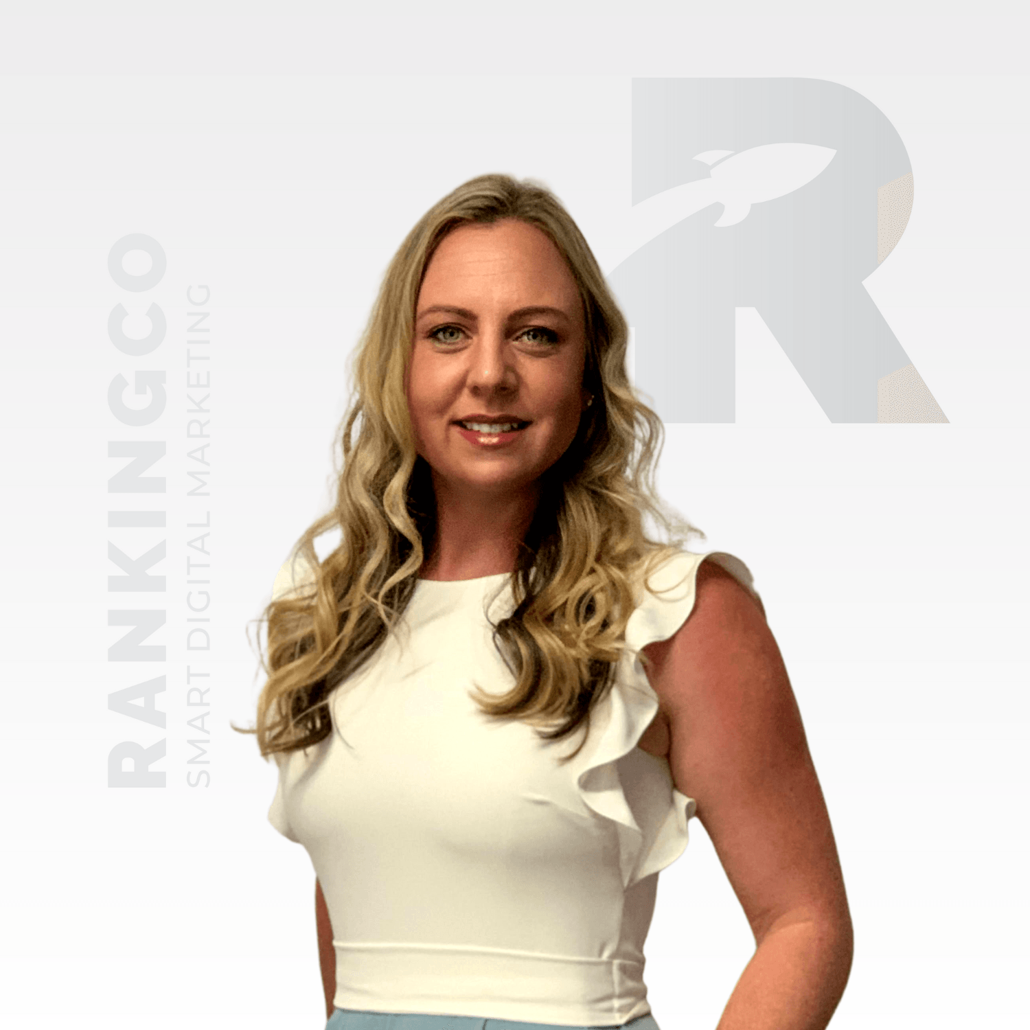 A woman in a white top is standing in front of a sign that says ranking co