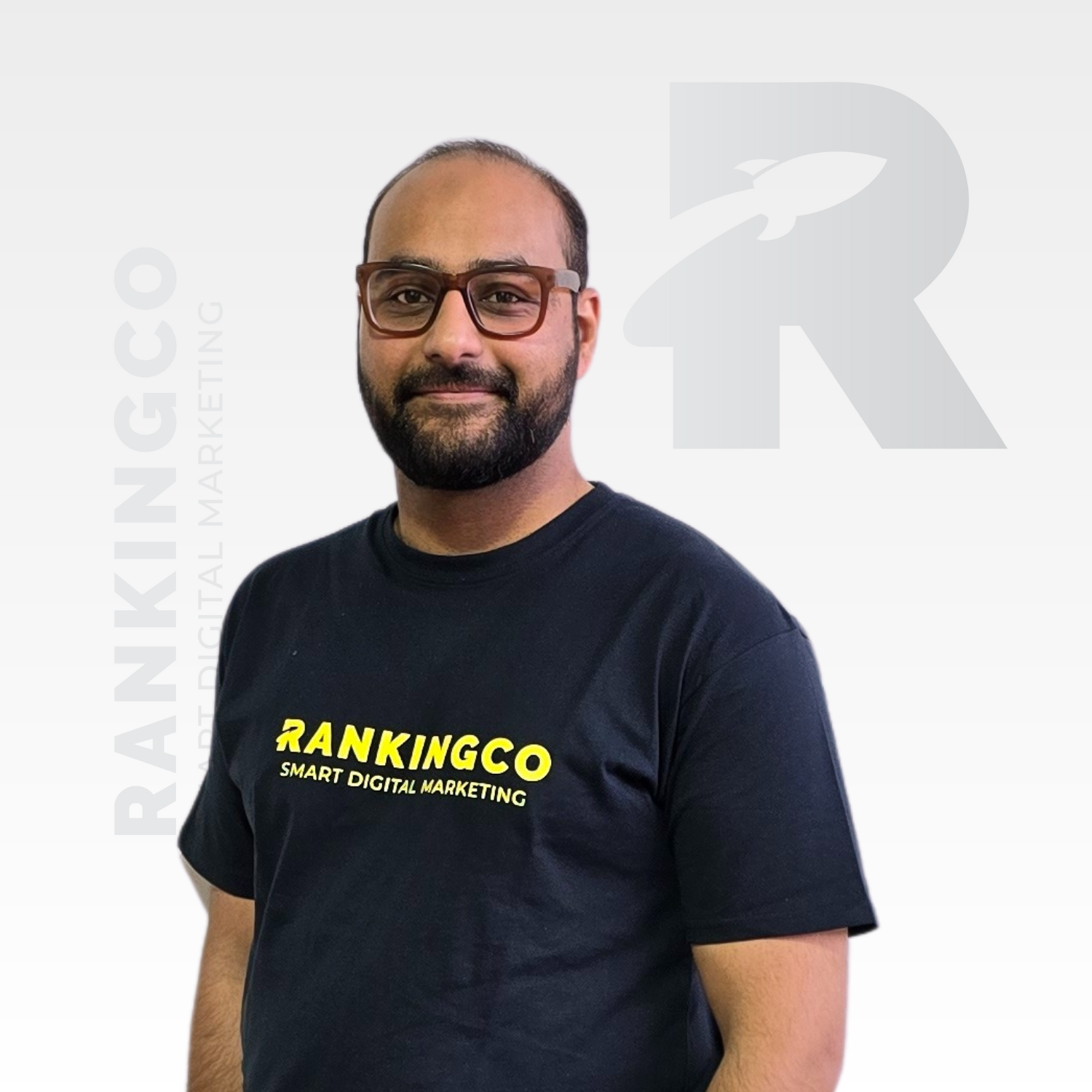 A man wearing glasses and a black shirt that says rankingco