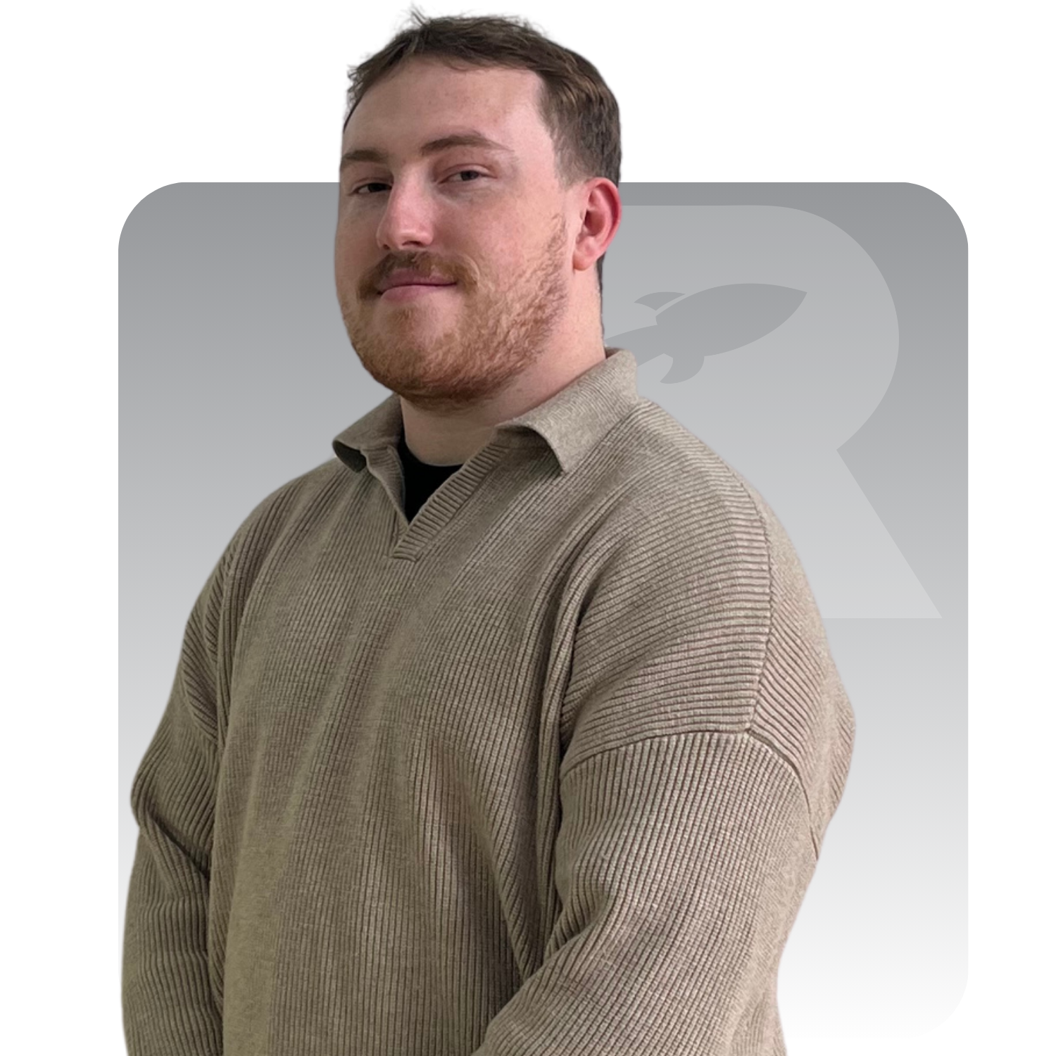 Portrait of a man in a long sleeve polo against a white background with a faint logo