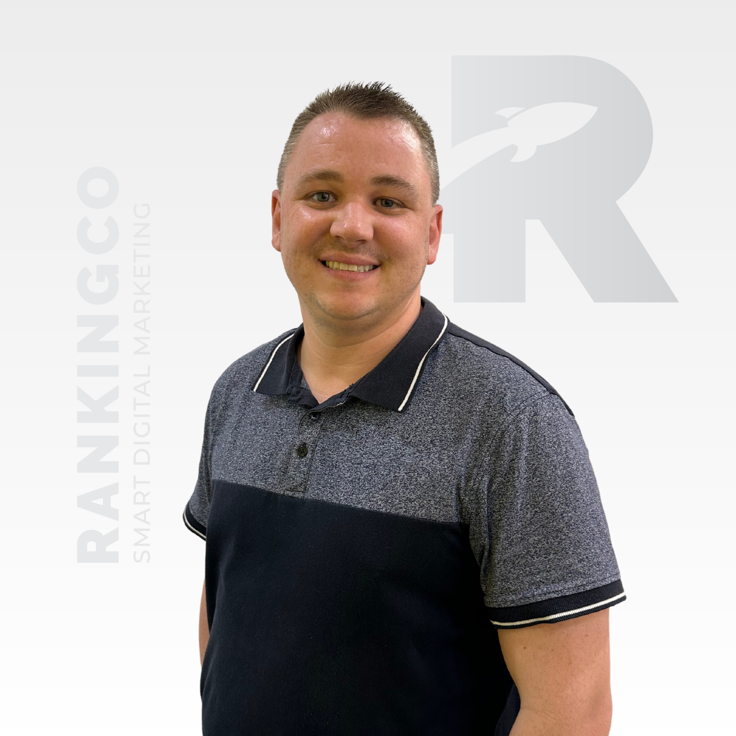 A man standing in front of a white background with the letter r on it