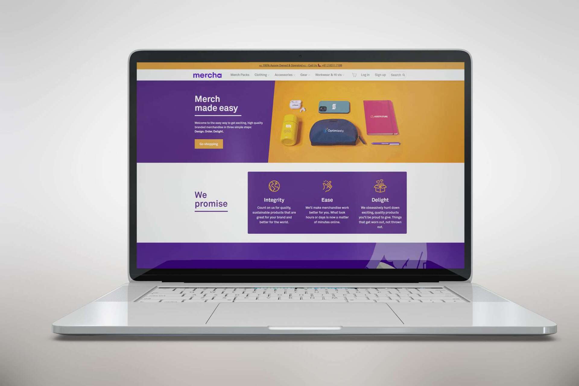 A laptop is open to a purple and yellow website