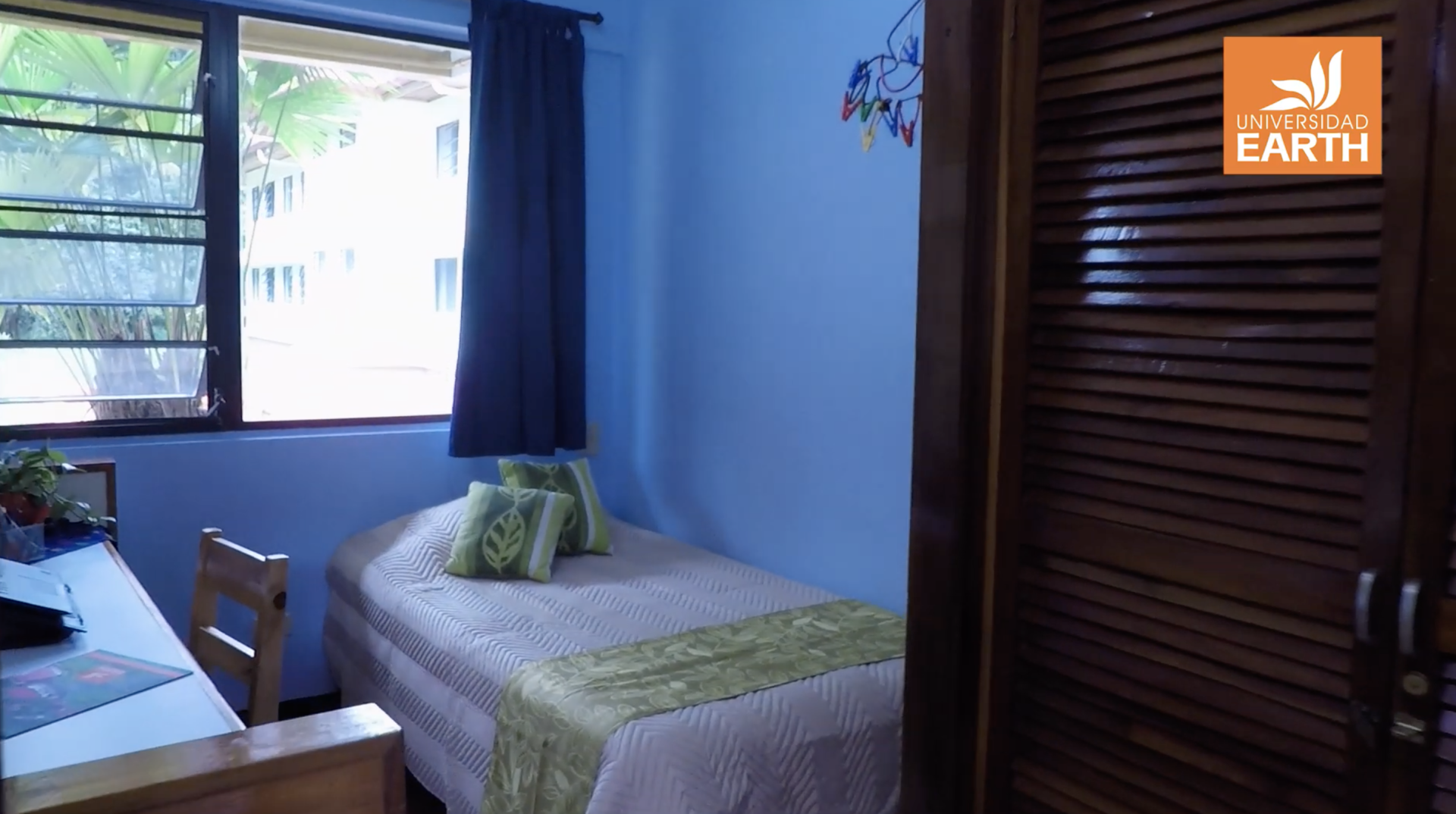 A bedroom with a single bed and a sign that says earth