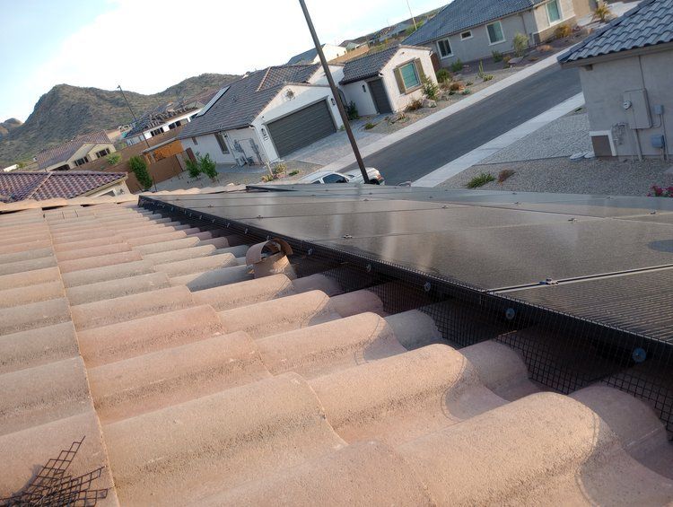 A roof with a row of solar panels on it.