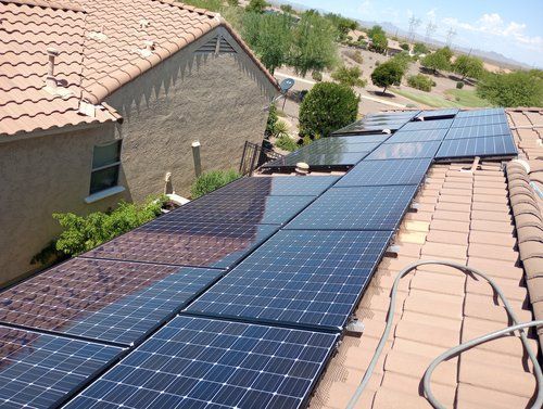 A row of solar panels on the roof of a house