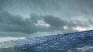 A solar panel in the rain with a cloudy sky in the background.