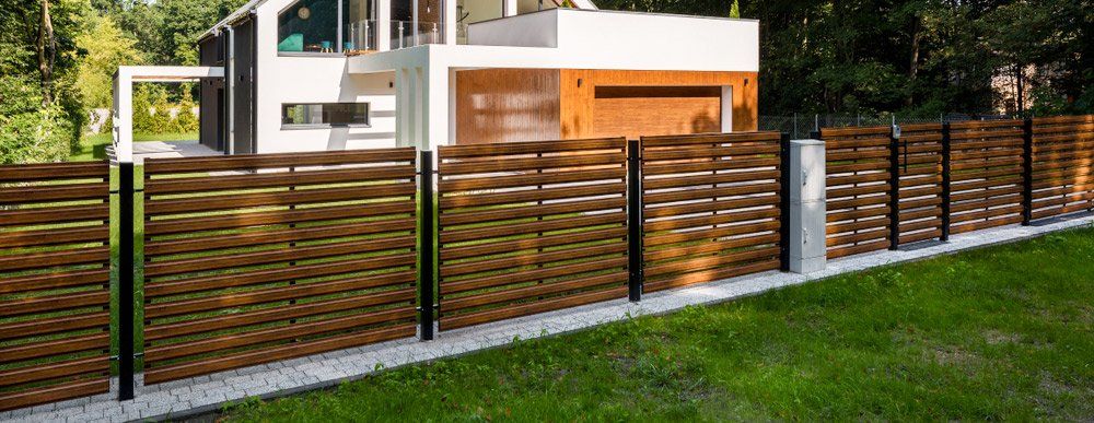 White House With Wood Style Fence — Gates & Fencing in Coffs Harbour, NSW