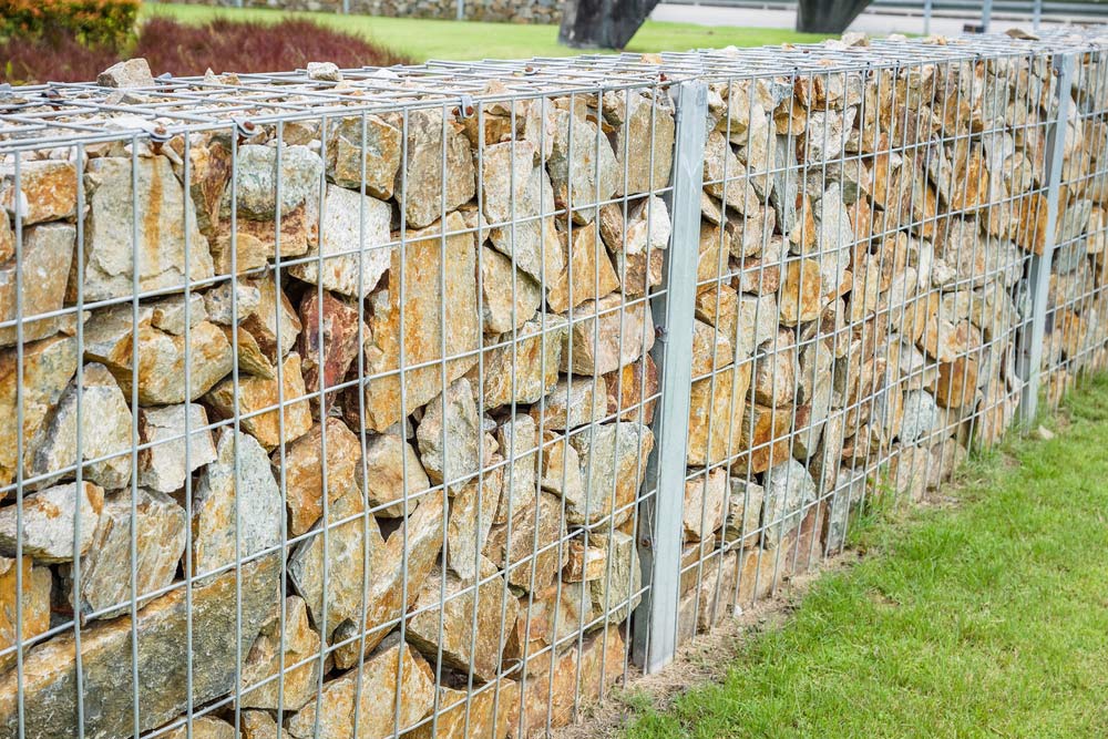 Stones in Metal Wire Cage — Gates & Fencing in Coffs Harbour, NSW