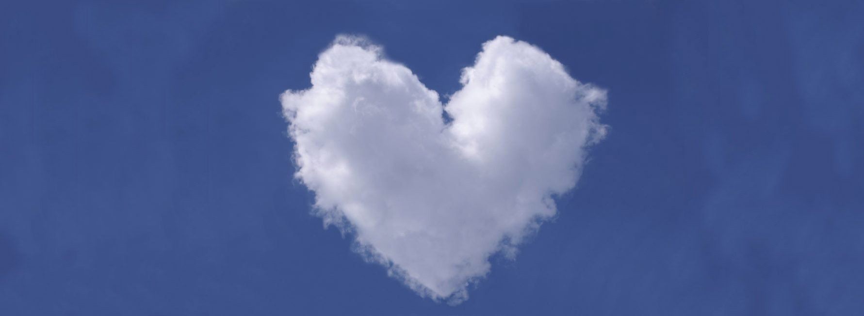 Image of a heart-shaped cloud in a blue sky