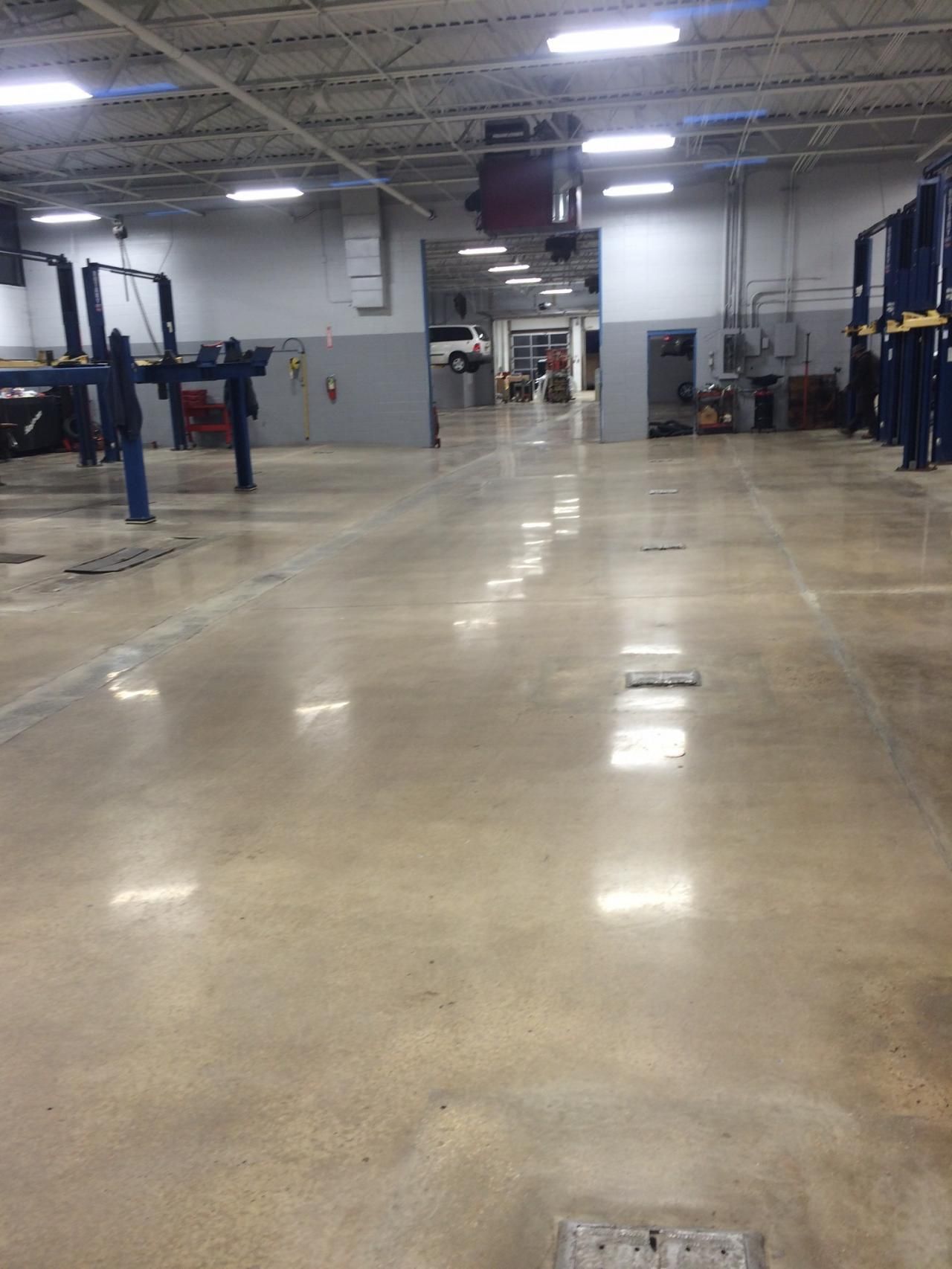 a large empty garage with a polished concrete floor .