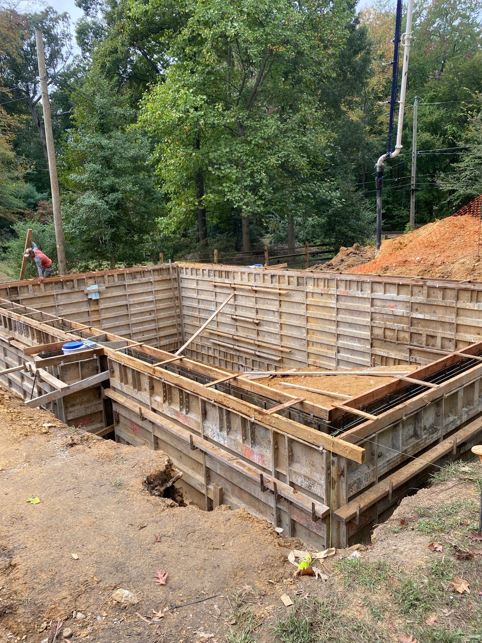 a large wooden structure  being built as a mold for a concrete foundation.