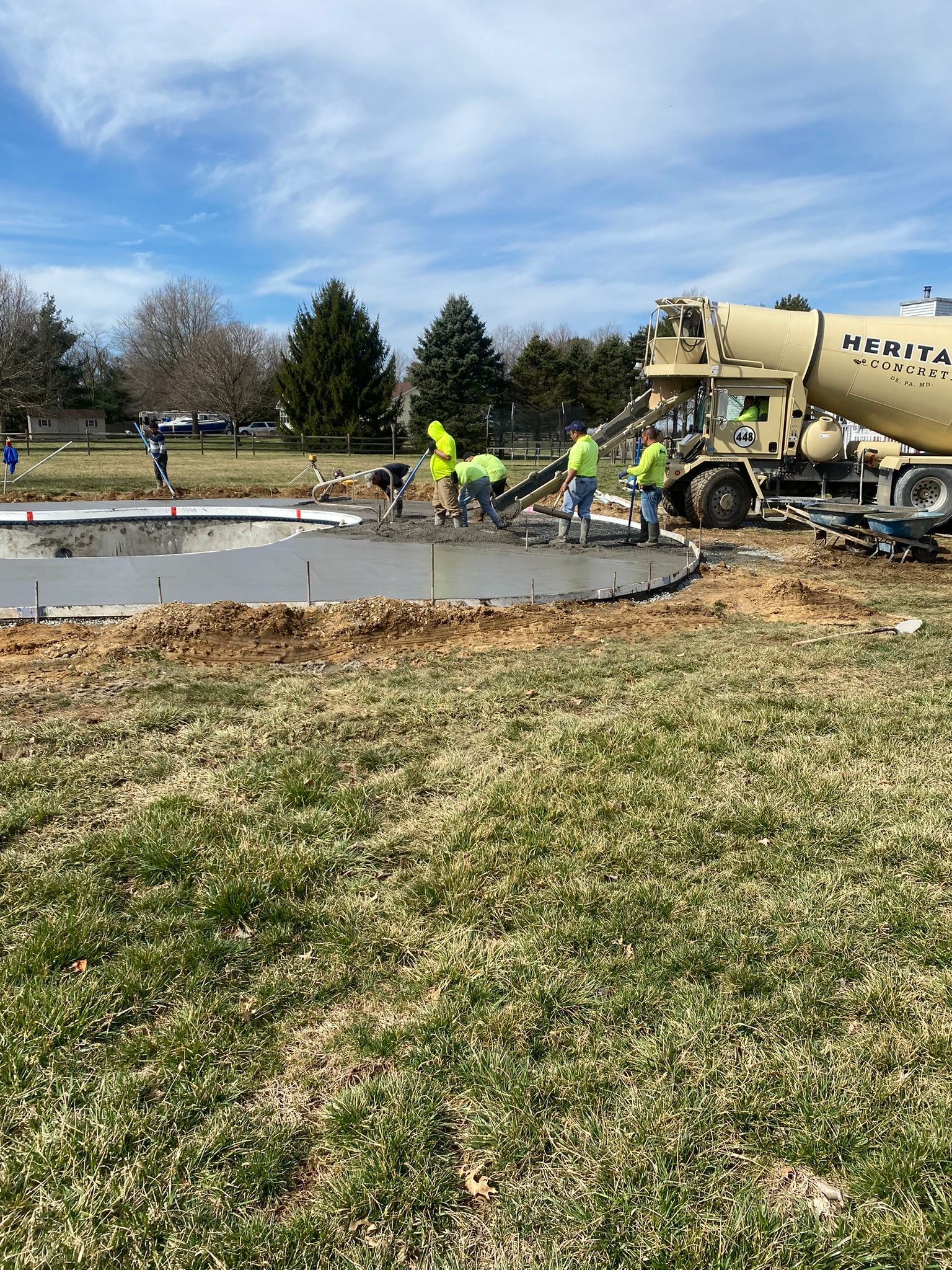 a group of construction workers are pouring concrete