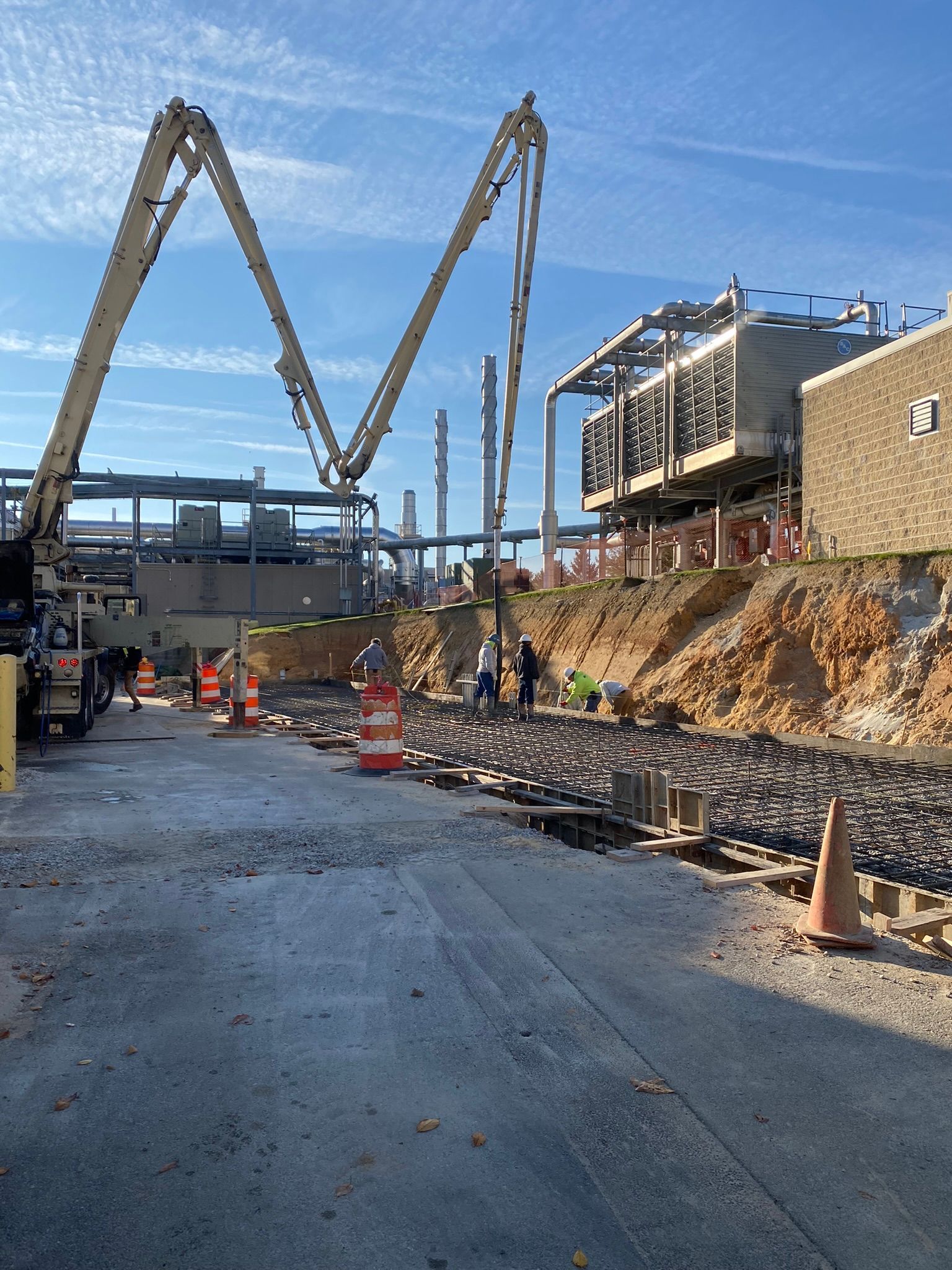 a construction site with a concrete pump in the middle of it .