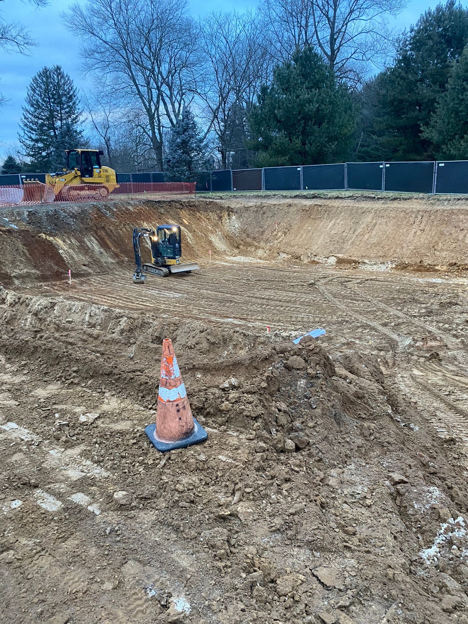 a construction site with a bulldozer excavating for a future foundation.
