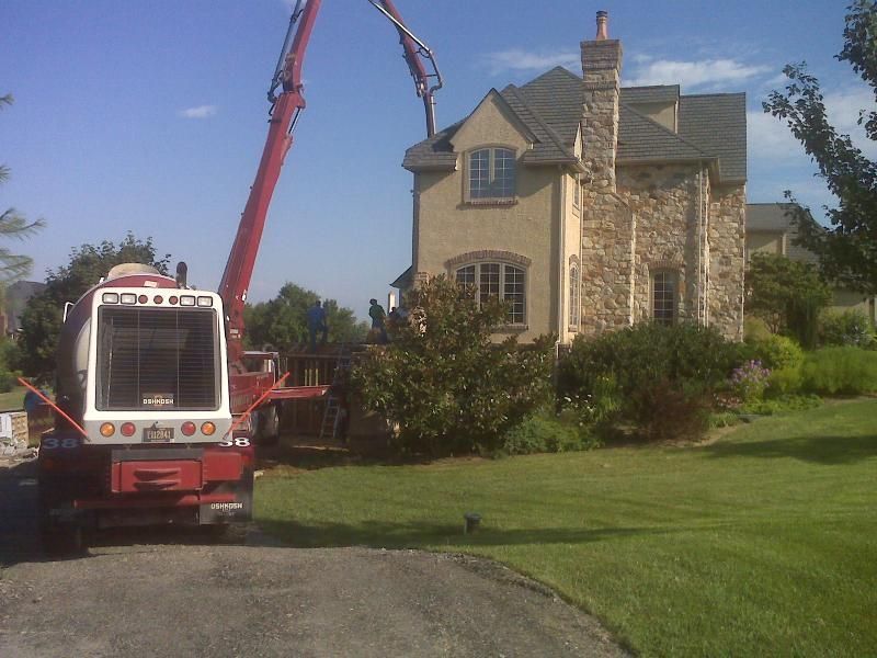 a red and white crane is parked in front of a house