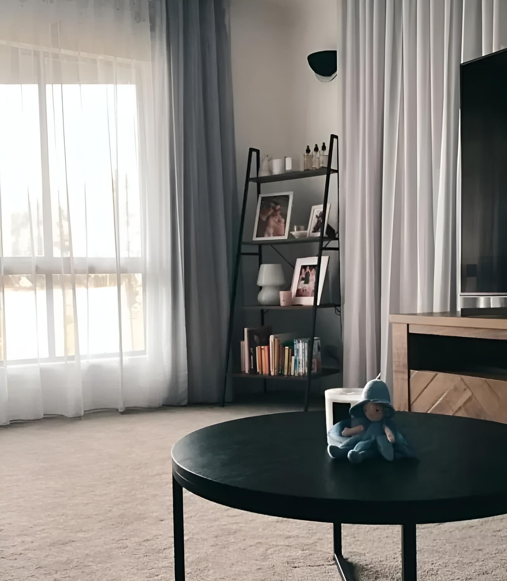 A Living Room With a Round Coffee Table and a Television — Mi-ekka Designs in Mackay, QLD