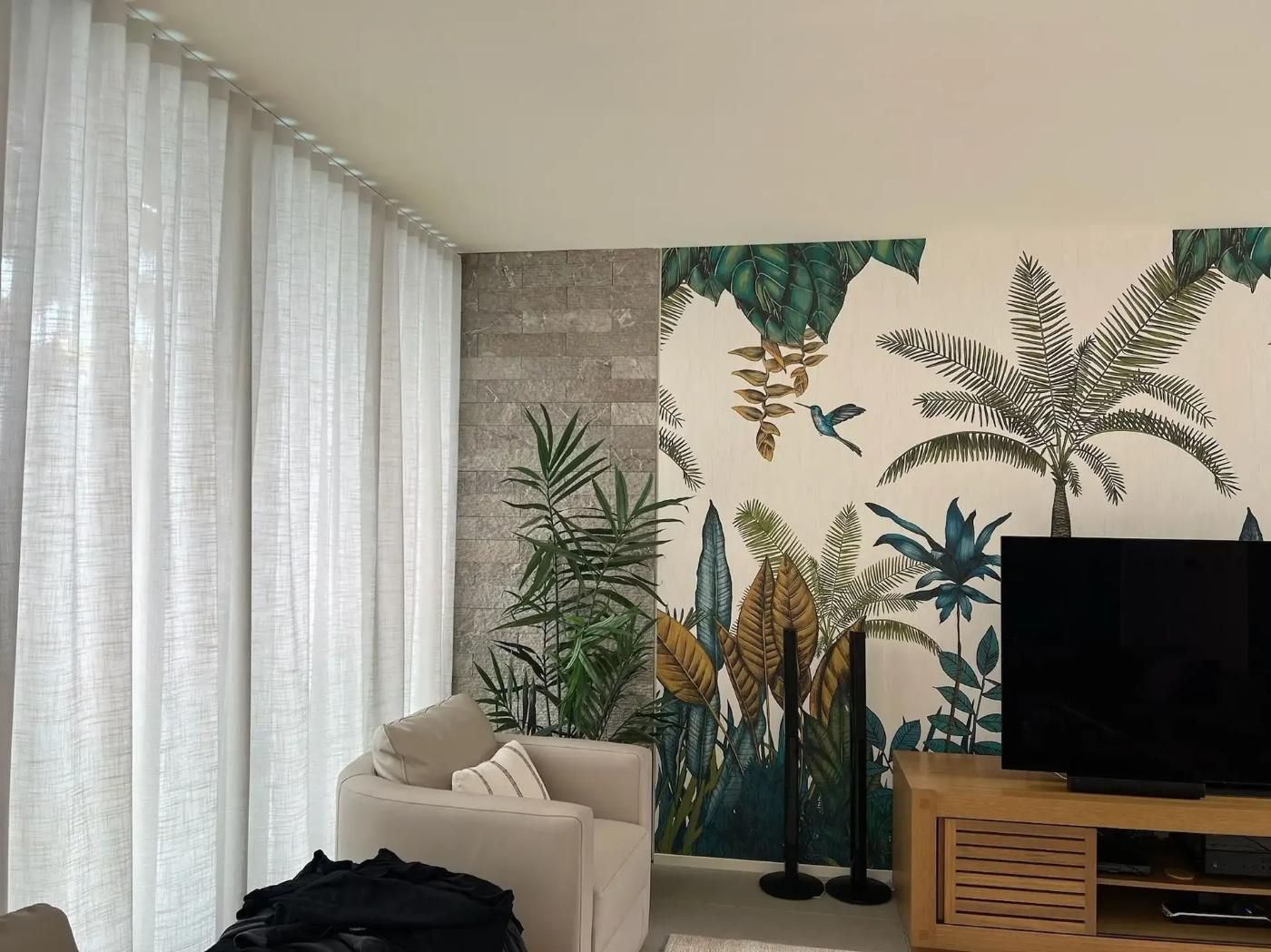 A Living Room With a Painting on the Wall and a Television — Mi-ekka Designs in Bowen, QLD