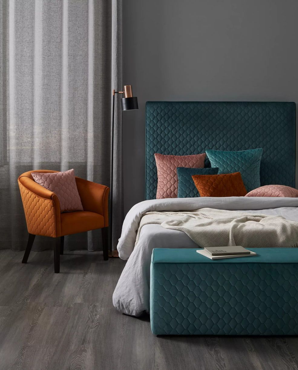 A Bedroom with A Bed, Chair, Lamps and Shutters on The Windows — Mi-ekka Designs in Cannonvale, QLD