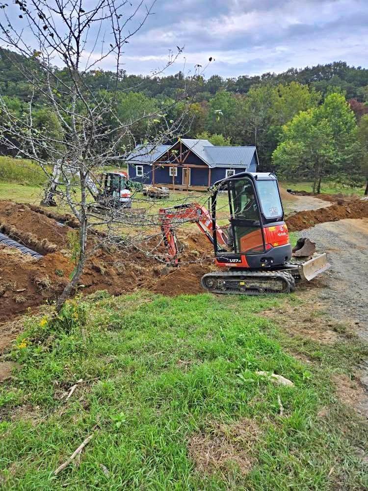 Backhoe and heavy equipment used to grade a slope in Boone, NC