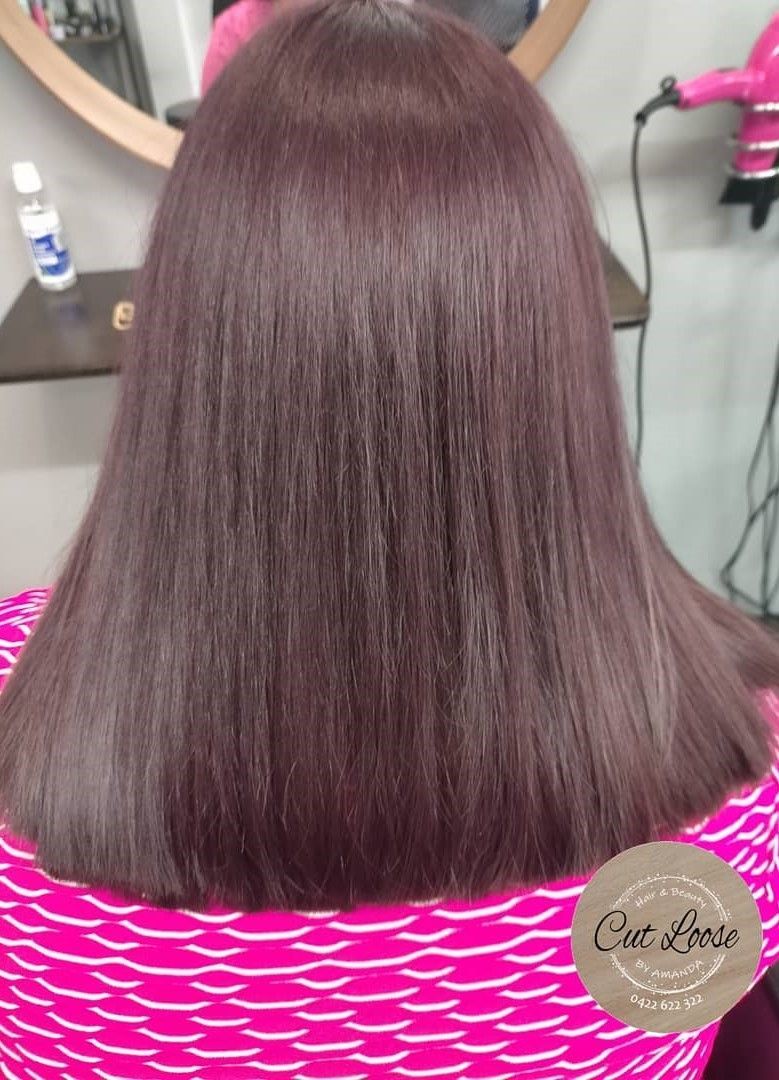 A Woman In A Pink Shirt Is Getting Her Hair Blow Dried — Cut Loose Haircare Outlet in Casino, NSW