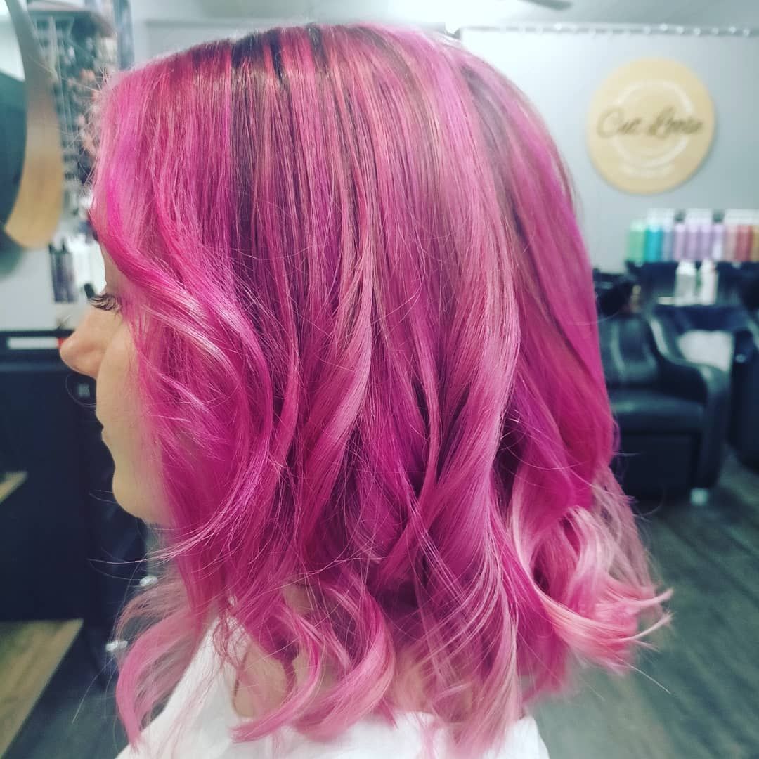 A Woman With Pink Hair Is Standing In A Salon — Cut Loose Haircare Outlet in Evans Head, NSW