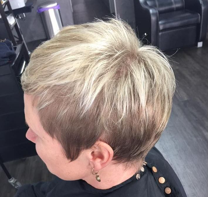 A Woman With Short Blonde Hair Is Wearing Earrings — Cut Loose Haircare Outlet in Casino, NSW 