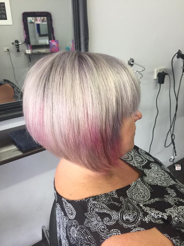A Woman Is Getting Her Hair Cut In A Salon — Cut Loose Haircare Outlet In Byron Bay, NSW