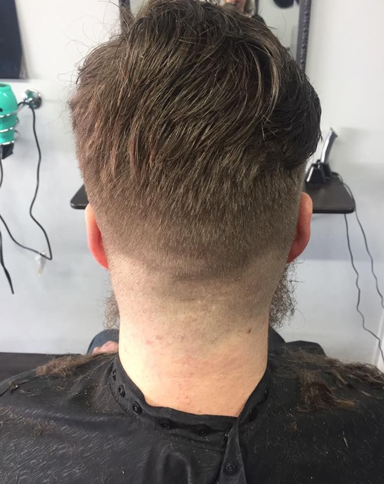 A Man With A Beard Is Getting His Hair Cut At A Barber Shop — Cut Loose Haircare Outlet In Ballina, NSW