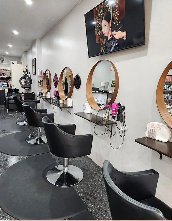 A Row Of Chairs In A Hair Salon With A Television On The Wall — Cut Loose Haircare Outlet in Lismore, NSW