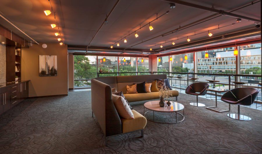 A room with a couch, chairs, and a table.