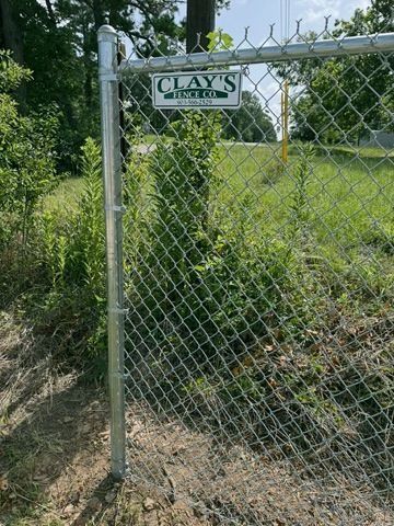 Chain-link fence with a sign reading