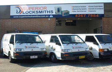 Three white emergency locksmiths van on the front of Superior Locksmiths place