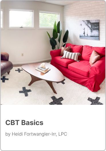 A living room with a red couch and a coffee table