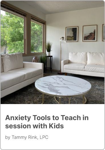 A living room with two white couches and a round coffee table