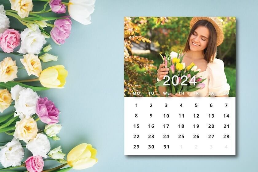 A calendar with flowers on a wooden table