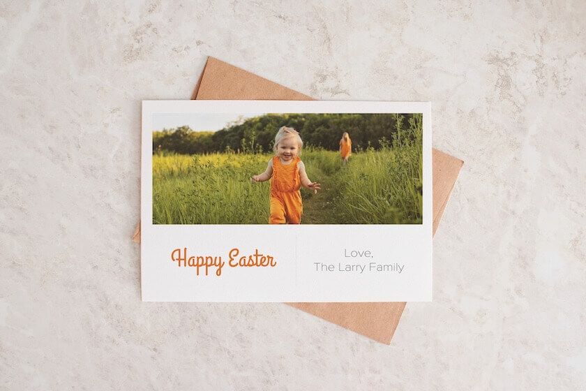 A happy easter card with a picture of a little girl blowing a dandelion.