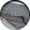 A close up of a roof with shingles missing