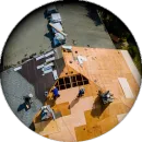 An aerial view of people working on a roof