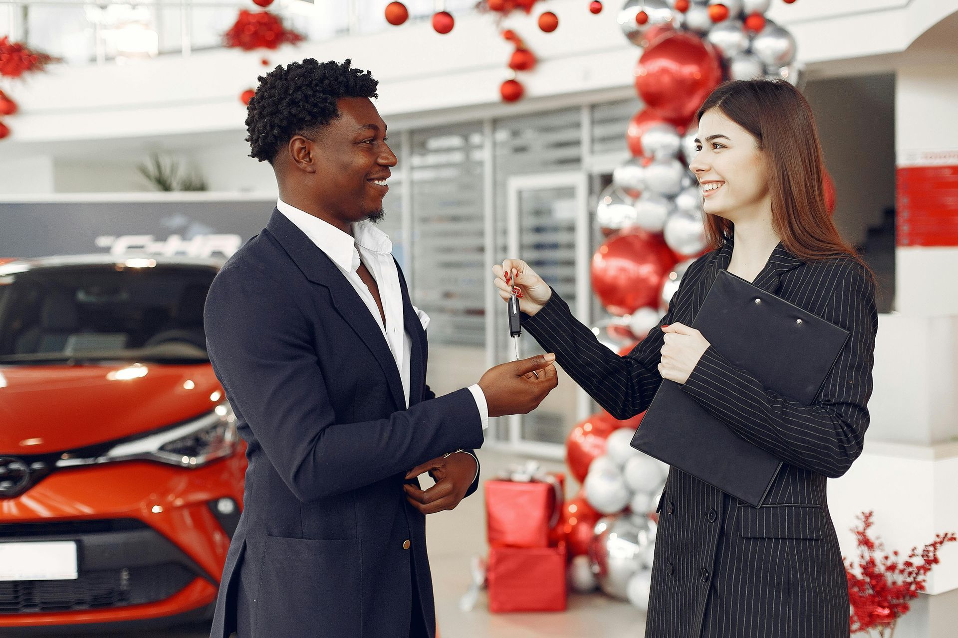 Happy car buyer receiving keys