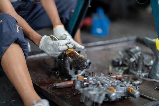 Technician working on a vehicle transmission, offering rebuilt transmission services Huntington IN