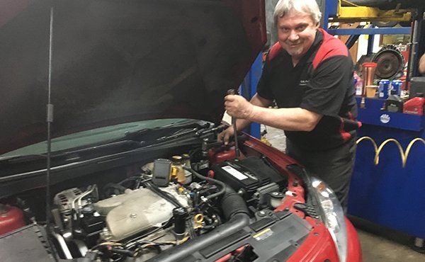 Mechanic Fixing The Engine — Fort Wayne, IN — Summit Transmission Inc
