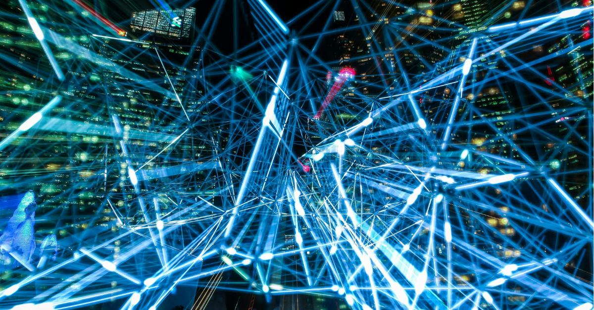 Network of glowing data lines over a cityscape, symbolizing digital connectivity