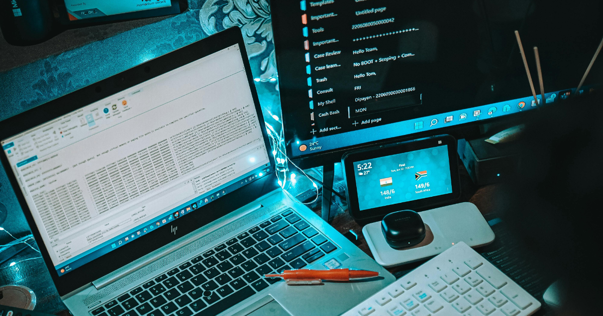 Close-up of dual-screen setup showing IT systems and real-time connectivity data