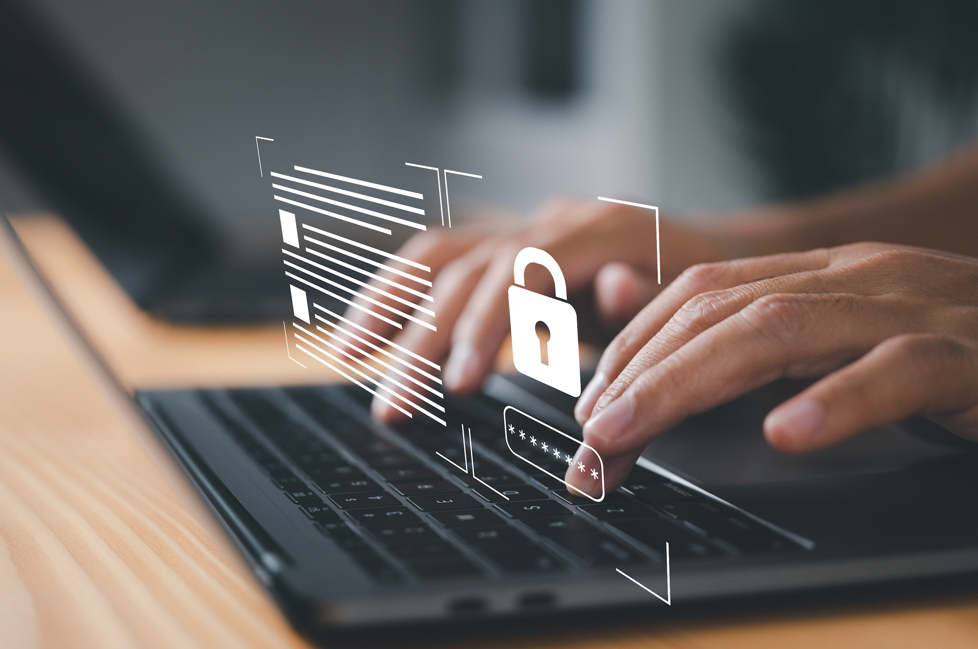 A person is typing on a laptop computer with a padlock coming out of the screen.