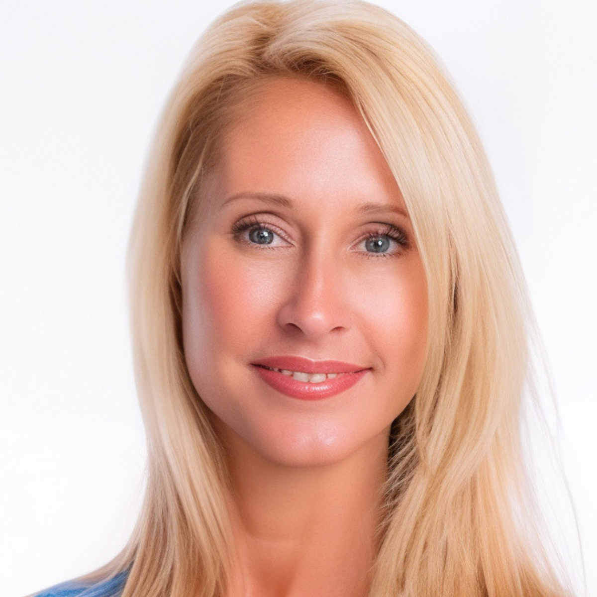 A woman with blonde hair and blue eyes smiles for the camera
