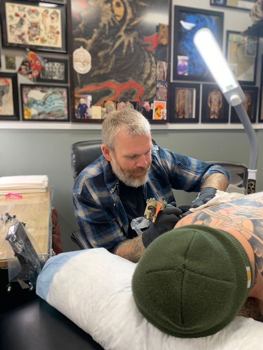 Tattoo artist Brian Bruno tattooing a client at Absolute Art Tattoo in Richmond, Virginia