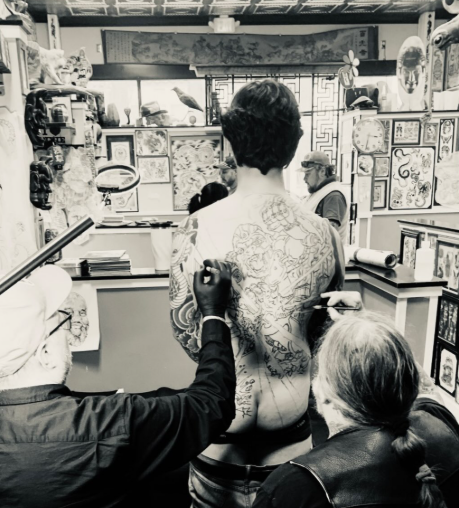 Tattoo artists Timothy Hoyer and Tim Lehi creating a custom back piece tattoo by hand at Absolute Art Tattoo Richmond VA