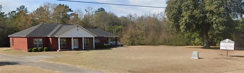 A large office building with a lot of windows on a sunny day.